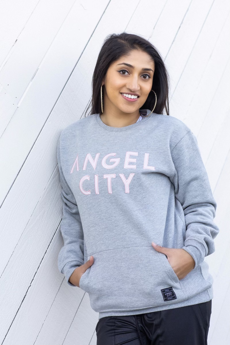 Support your ACFC squad and stay warm in our Angel City FC Unisex Embroidered Felt Wordmark Grey Crewneck Sweater. The sweater features an embroidered felt and satin Sol Rosa ACFC wordmark on the front chest and a front pouch where you can keep all your belongings.